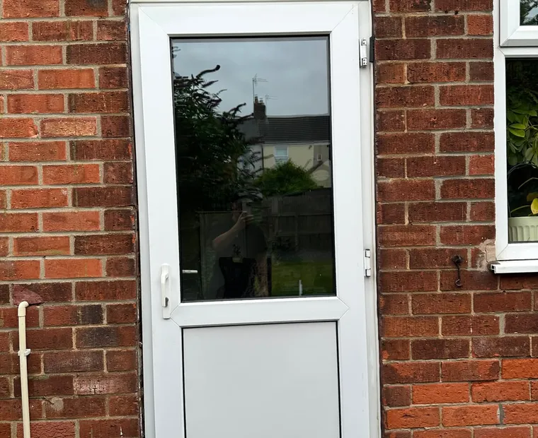 White glazed entrance door installation