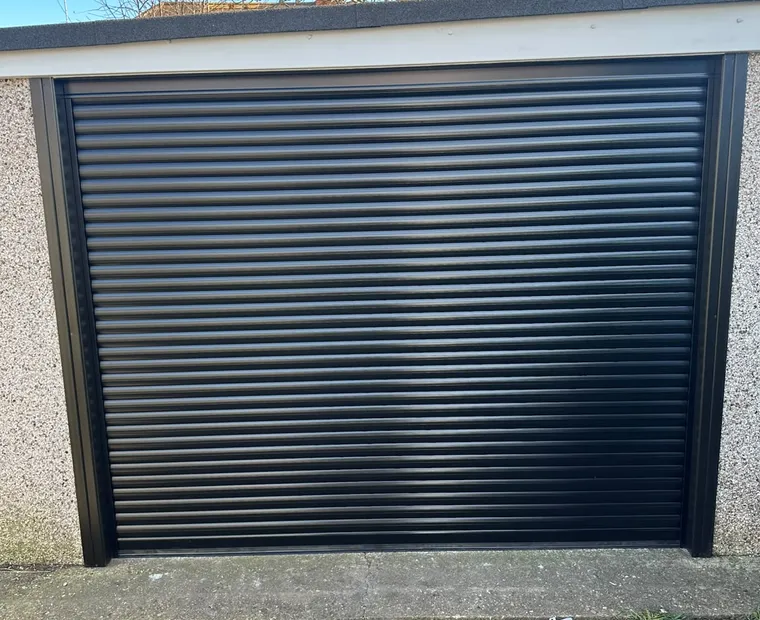 Black roller garage door in a rendered opening